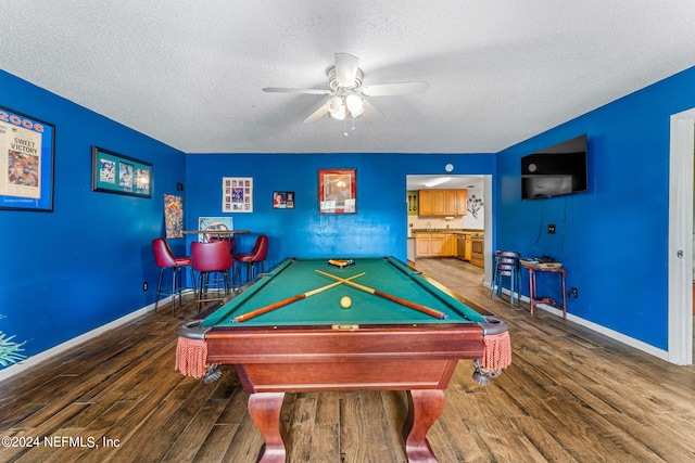 playroom featuring pool table, ceiling fan, dark hardwood / wood-style floors, and a textured ceiling