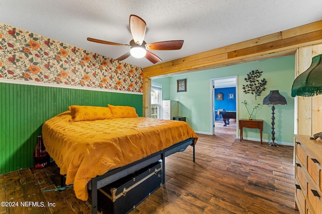 bedroom featuring ceiling fan, a textured ceiling, and dark wood-type flooring