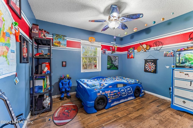 bedroom with wood-type flooring, ceiling fan, and a textured ceiling