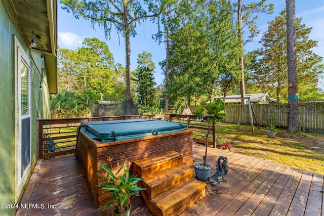 wooden terrace featuring a covered hot tub