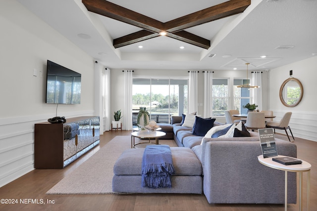 living room featuring beamed ceiling, hardwood / wood-style flooring, and coffered ceiling