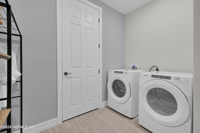 clothes washing area with washer and clothes dryer