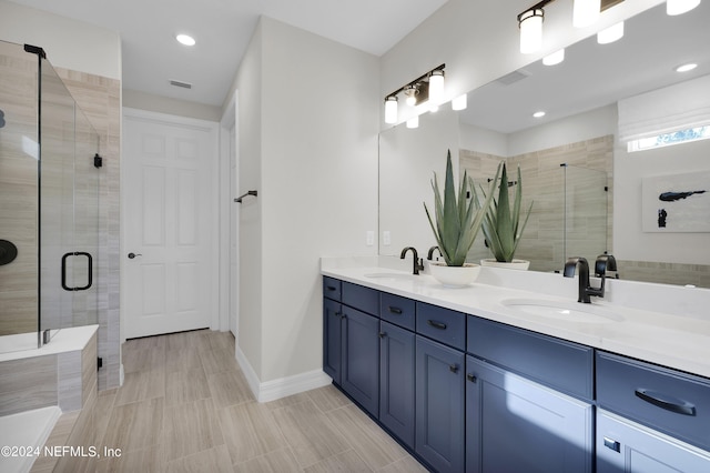 bathroom with a shower with door and vanity