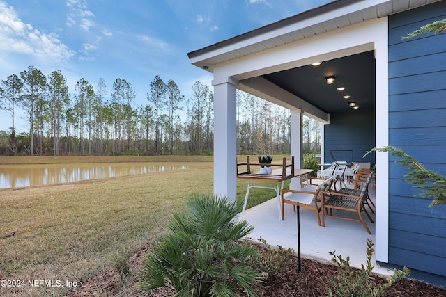 view of patio featuring a water view and outdoor lounge area