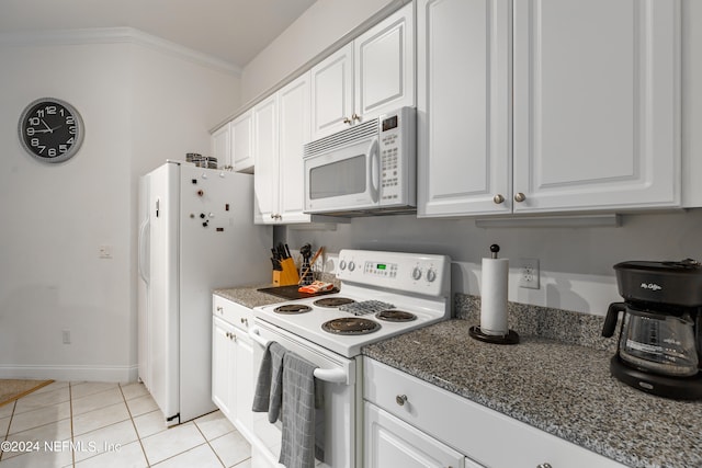 kitchen featuring dark stone countertops, white appliances, light tile patterned flooring, crown molding, and white cabinetry