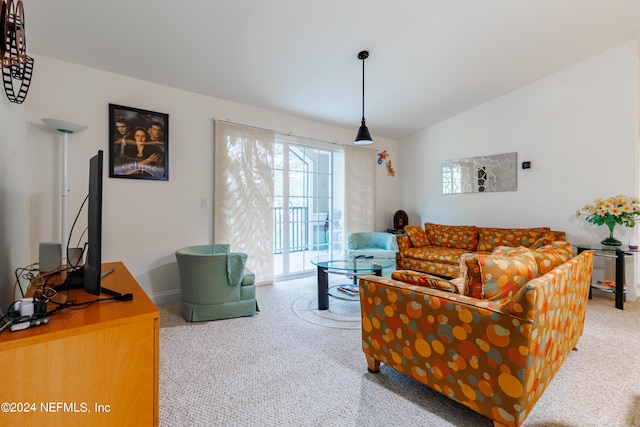 living room featuring lofted ceiling and light colored carpet