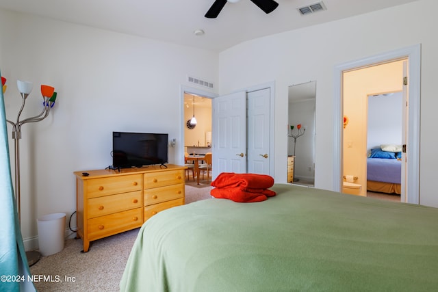 bedroom with ensuite bath, carpet, and ceiling fan