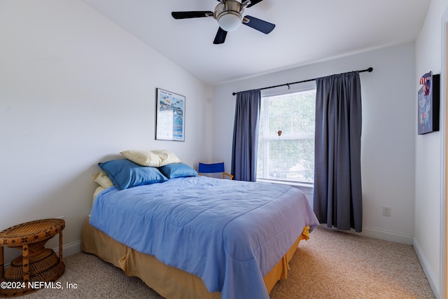 carpeted bedroom featuring vaulted ceiling and ceiling fan