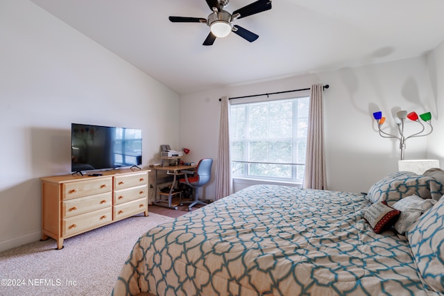 bedroom with ceiling fan, lofted ceiling, and light carpet