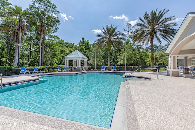 view of swimming pool featuring a patio area