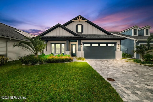 view of front of house featuring a garage and a lawn