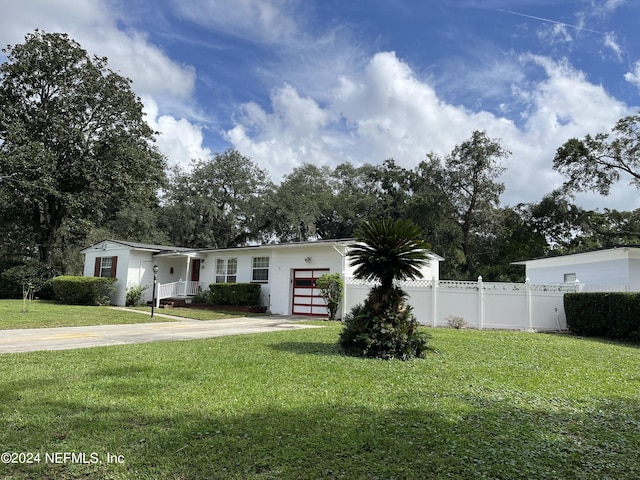 view of front of property with a front lawn and a garage