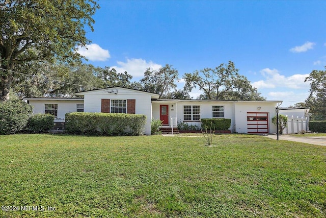 ranch-style home featuring a front yard and a garage