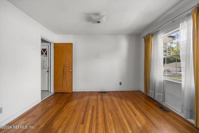 spare room featuring hardwood / wood-style floors