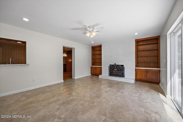 929 Bordeau Ave W, Jacksonville, FL 32211 - unfurnished living room with recessed lighting, built in shelves, a brick fireplace, baseboards, and a ceiling fan
