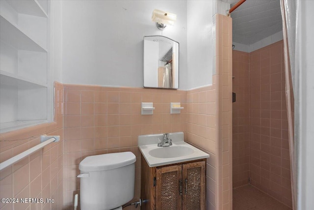 bathroom featuring tile walls, vanity, curtained shower, and toilet