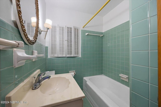 929 Bordeau Ave W, Jacksonville, FL 32211 - bathroom featuring bathing tub / shower combination, vanity, and tile walls