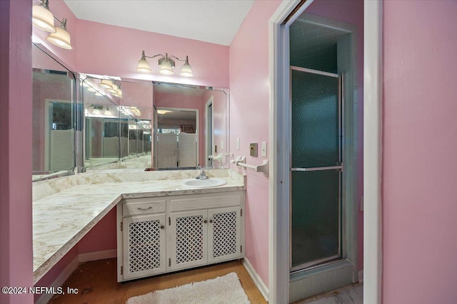 929 Bordeau Ave W, Jacksonville, FL 32211 - bathroom featuring baseboards, a shower with door, and vanity