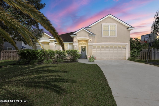 front facade with a garage and a yard