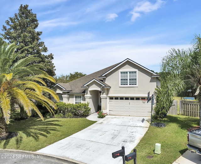 view of front of house featuring a garage and a front yard