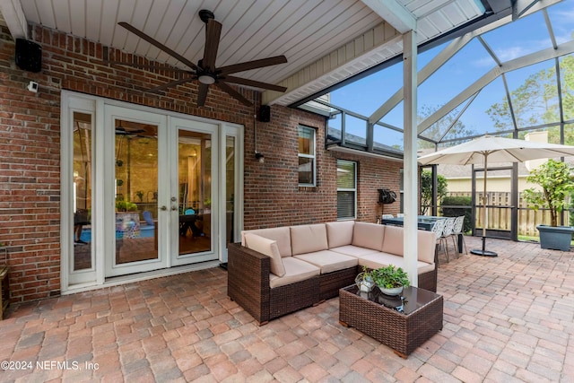 view of patio featuring french doors, glass enclosure, and an outdoor living space