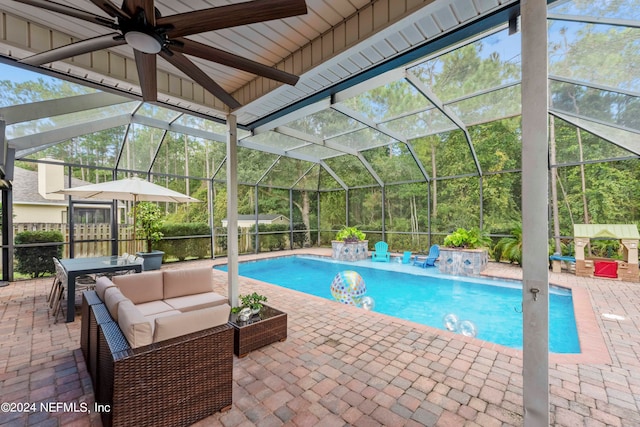 view of pool with a lanai, a patio area, pool water feature, and outdoor lounge area