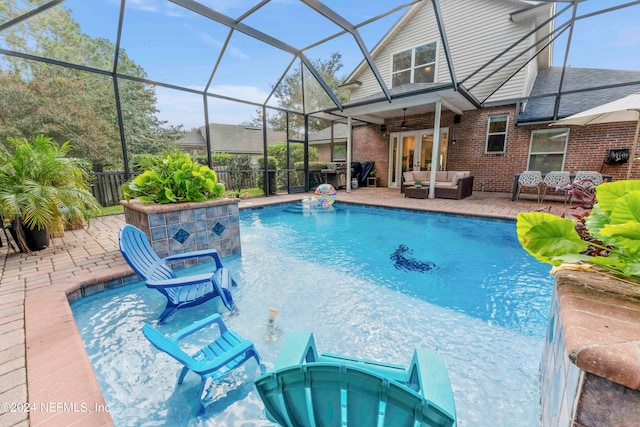 view of swimming pool featuring an outdoor hangout area, ceiling fan, glass enclosure, pool water feature, and a patio area