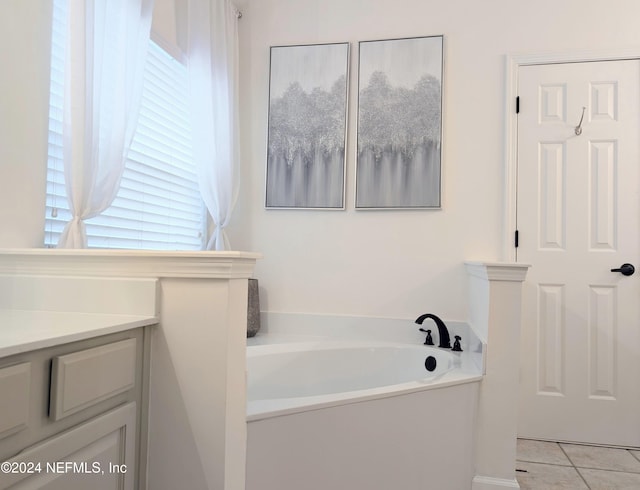 bathroom featuring vanity, a tub, and tile patterned floors