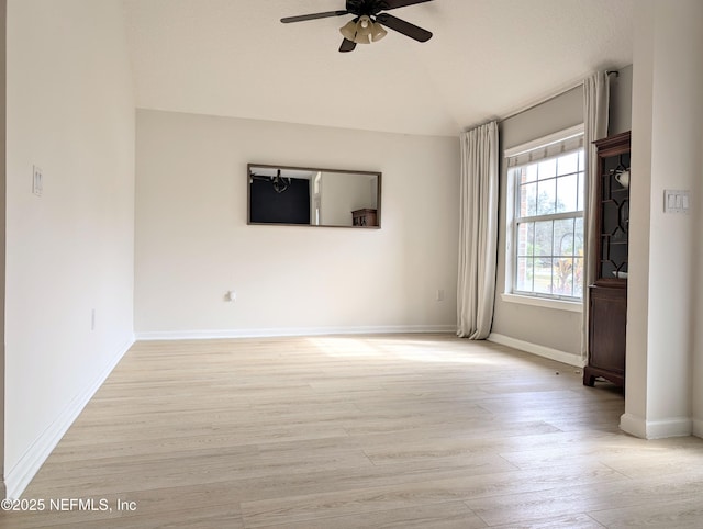 spare room featuring vaulted ceiling, ceiling fan, and light hardwood / wood-style floors