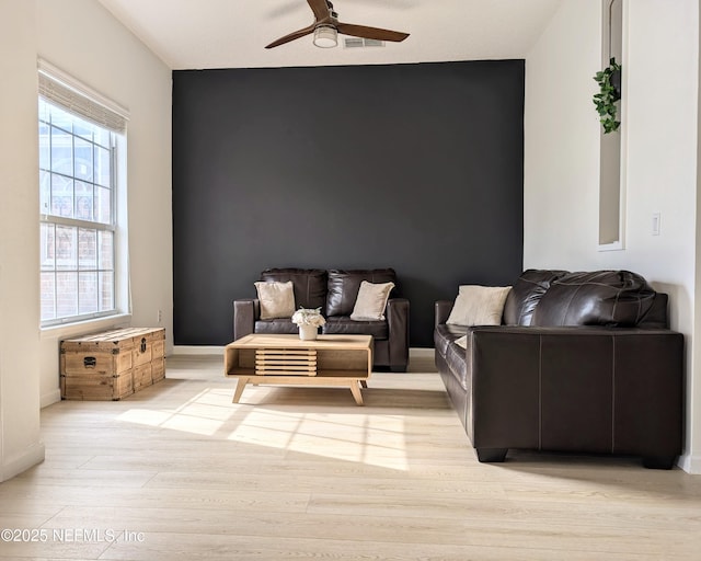 sitting room with ceiling fan and light hardwood / wood-style flooring