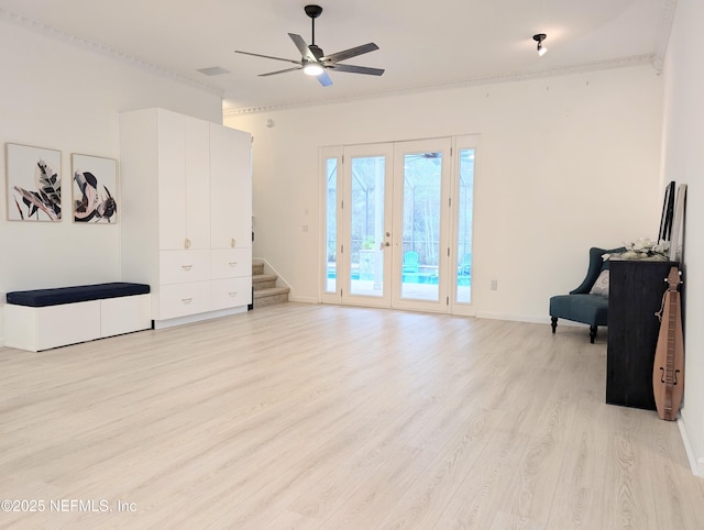 interior space with ceiling fan, light hardwood / wood-style flooring, french doors, and crown molding