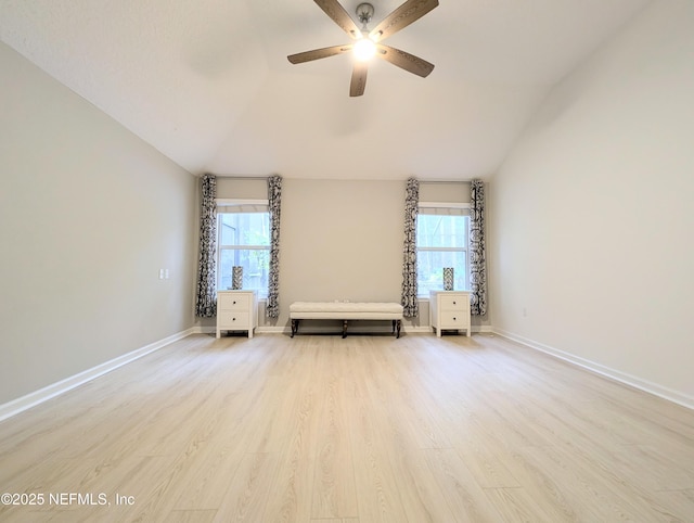 spare room with light hardwood / wood-style floors, ceiling fan, lofted ceiling, and plenty of natural light