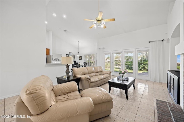 tiled living room with high vaulted ceiling and ceiling fan