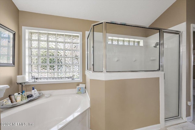 bathroom with independent shower and bath and a textured ceiling