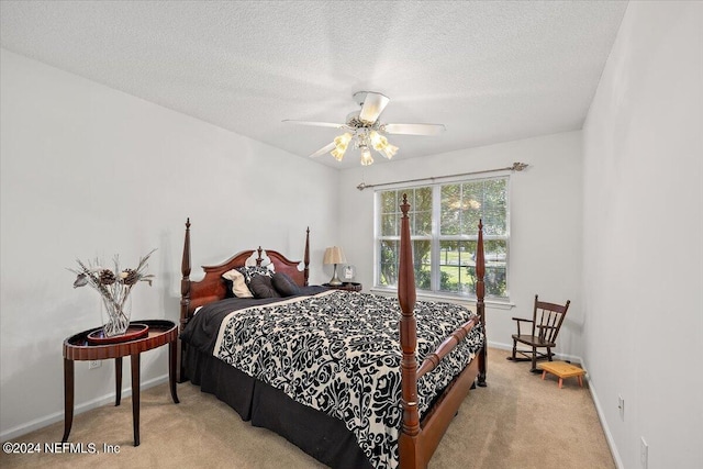 carpeted bedroom featuring a textured ceiling and ceiling fan