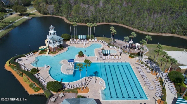 view of pool with a water view and a patio area