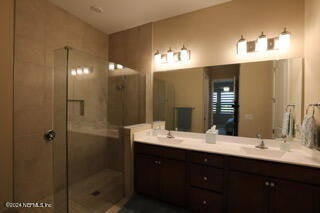 bathroom featuring vanity and an enclosed shower