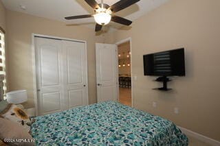 bedroom featuring ceiling fan and a closet