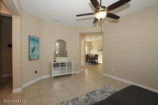 hallway featuring an inviting chandelier and tile patterned flooring