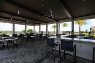 view of patio featuring an outdoor bar and ceiling fan