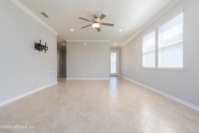 tiled spare room featuring ceiling fan and crown molding