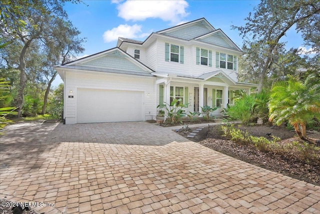 view of front of house with covered porch and a garage