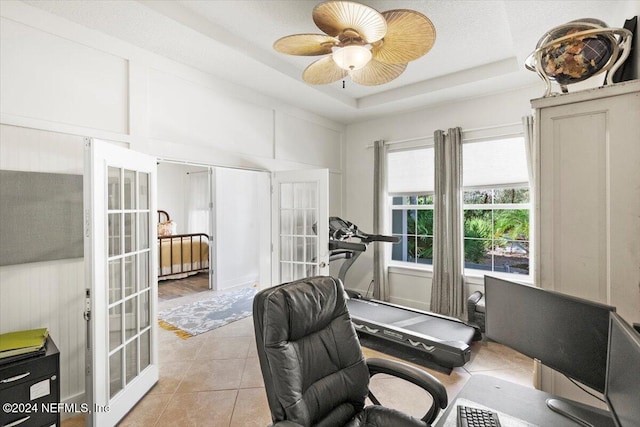 office area featuring french doors, light tile patterned floors, a raised ceiling, and ceiling fan