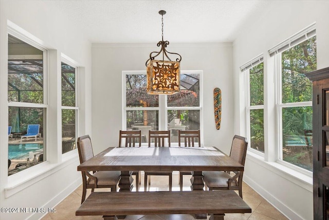 tiled dining space with a wealth of natural light and a textured ceiling