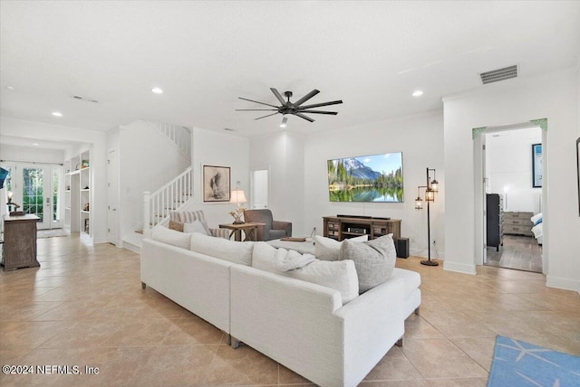 living room with light tile patterned flooring, a fireplace, and ceiling fan