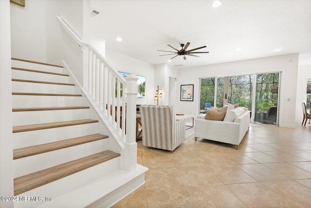 living room featuring ceiling fan and light tile patterned flooring