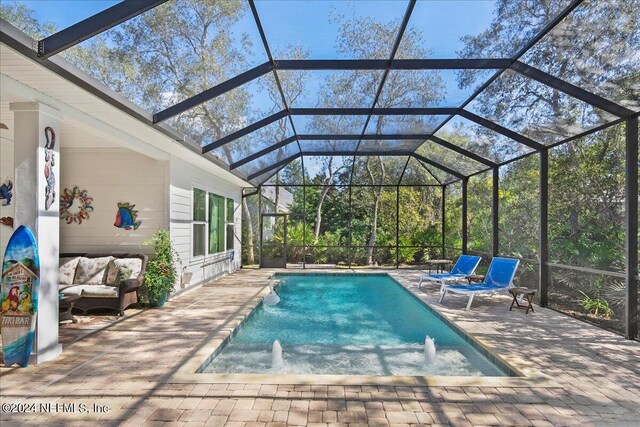 view of swimming pool featuring a patio, pool water feature, and a lanai