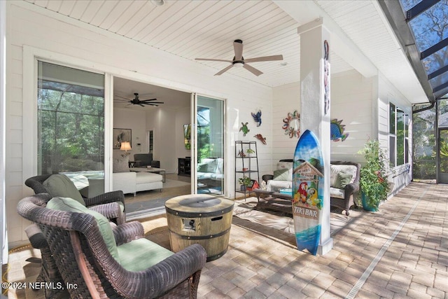 view of patio / terrace with a lanai, an outdoor hangout area, and ceiling fan