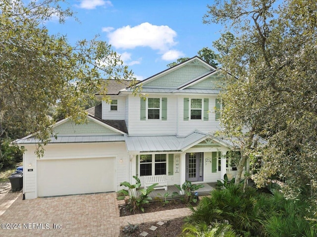 view of front of property with covered porch and a garage