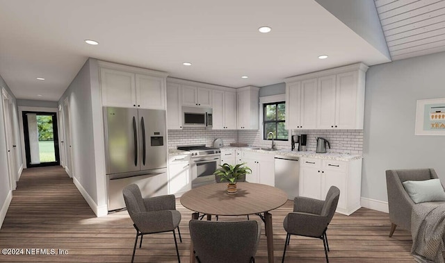 kitchen featuring stainless steel appliances, a wealth of natural light, wood-type flooring, and sink